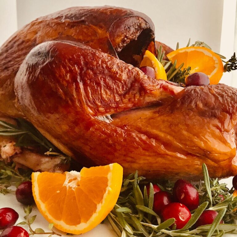 A smoked turkey on a plate.