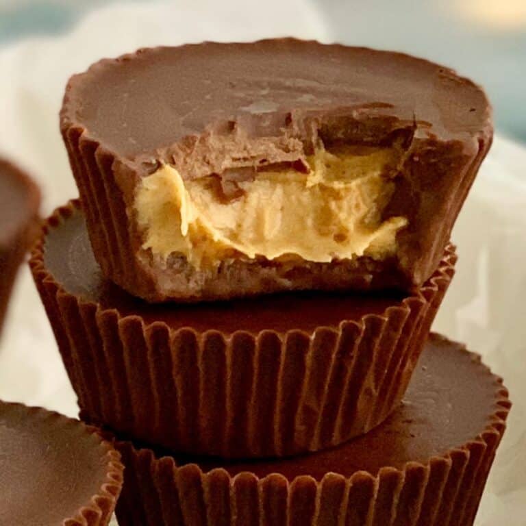 A small stack of homemade peanut butter cups with the top one missing a bite.