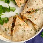 A few slices of a gluten and dairy free quesadilla on a plate.