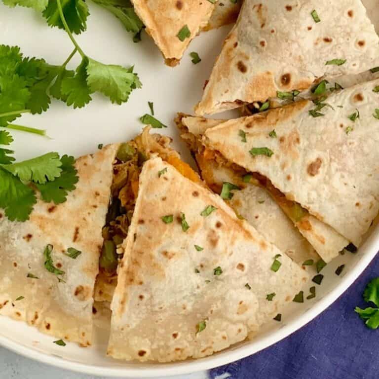 A few slices of a gluten and dairy free quesadilla on a plate.