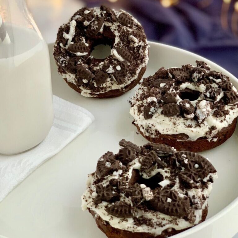 A white plate with a few gluten free and dairy free Oreo Donuts on it.