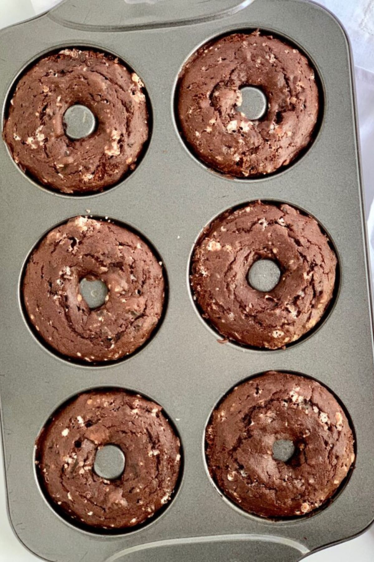 Baked oreo donuts in a donut pan.