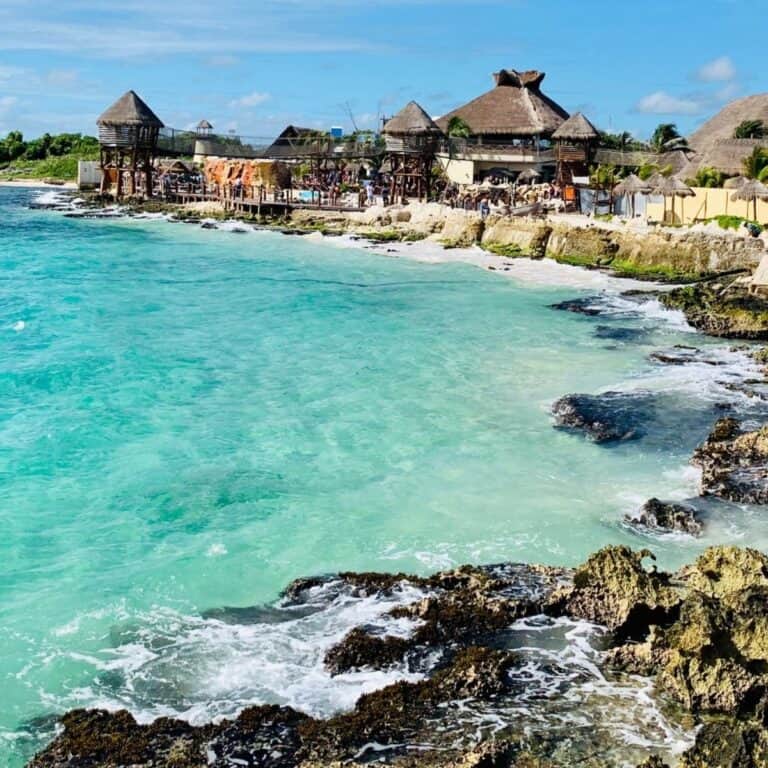 Beach with blue water and rocks.