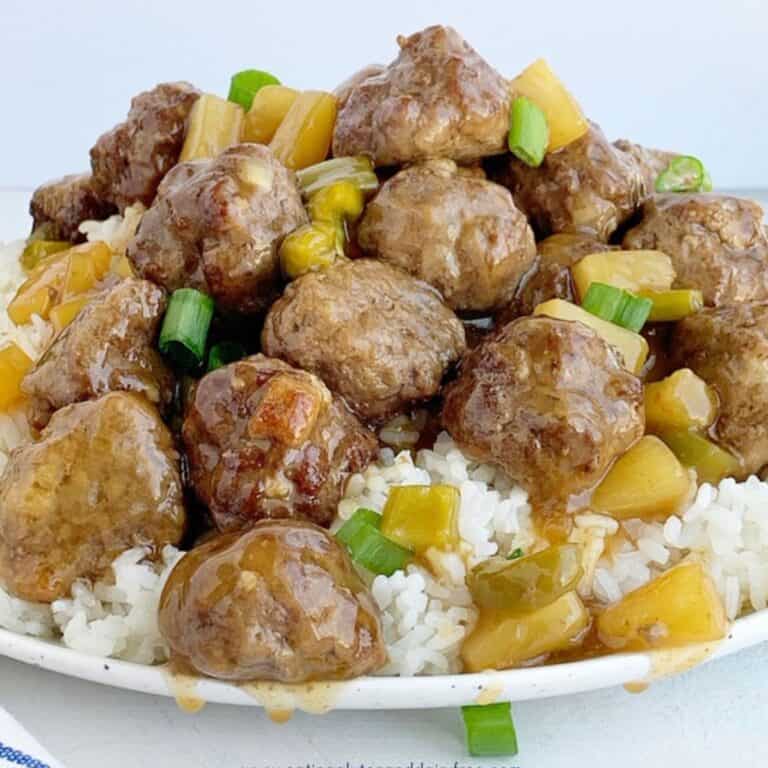 A plate of sweet and sour meatballs recipe on a plate with rice.