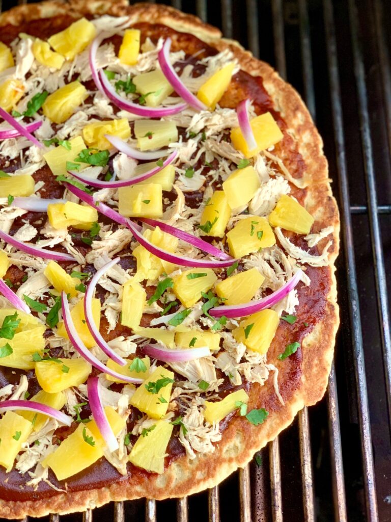 This is the perfect gluten and dairy free grilled Hawaiian BBQ chicken pizza. Each bite is full of smokey BBQ chicken and pineapple flavor.#glutenfree #dairyfree #grilledpizza