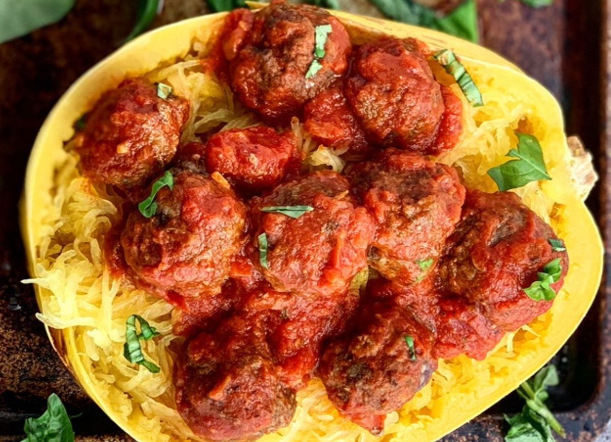 Looking down on an open spaghetti squash with Homemade Gluten Free Meatballs and marinara sauce. 