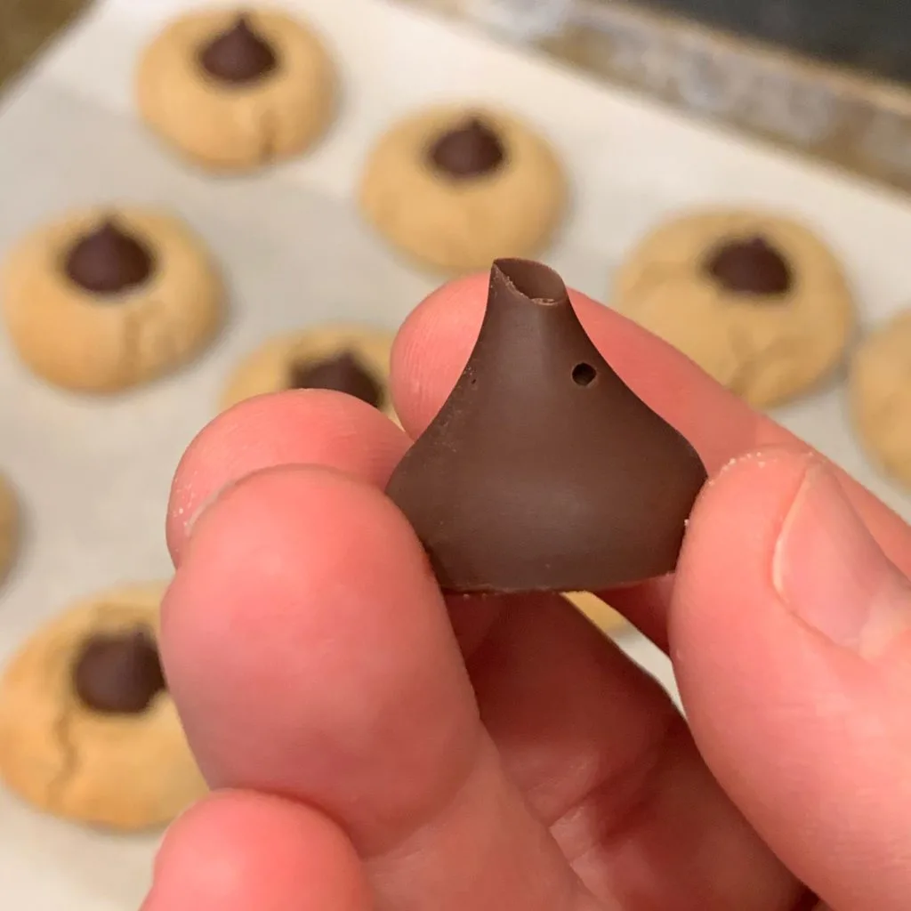 a chocolate kiss with a hole and missing tip