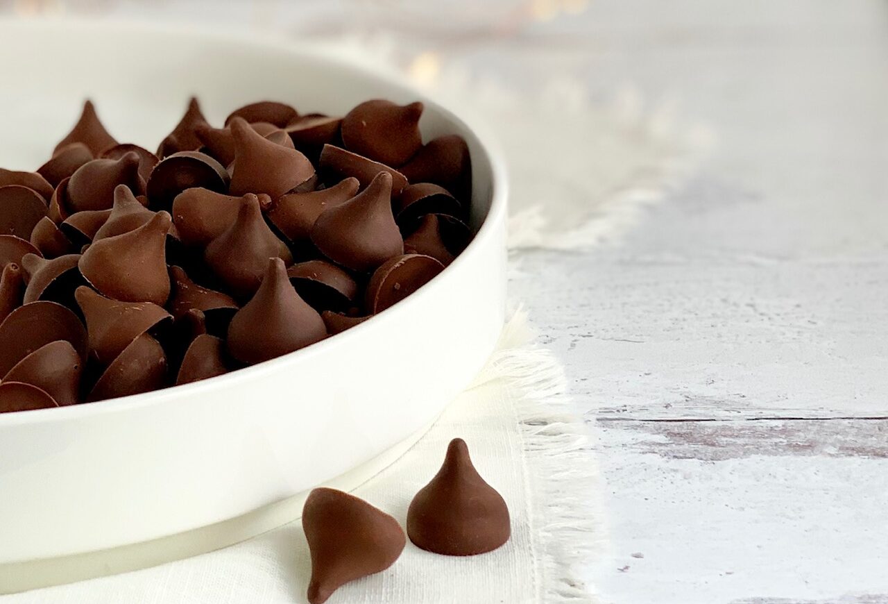 A large white serving platter filled with chocolate kisses