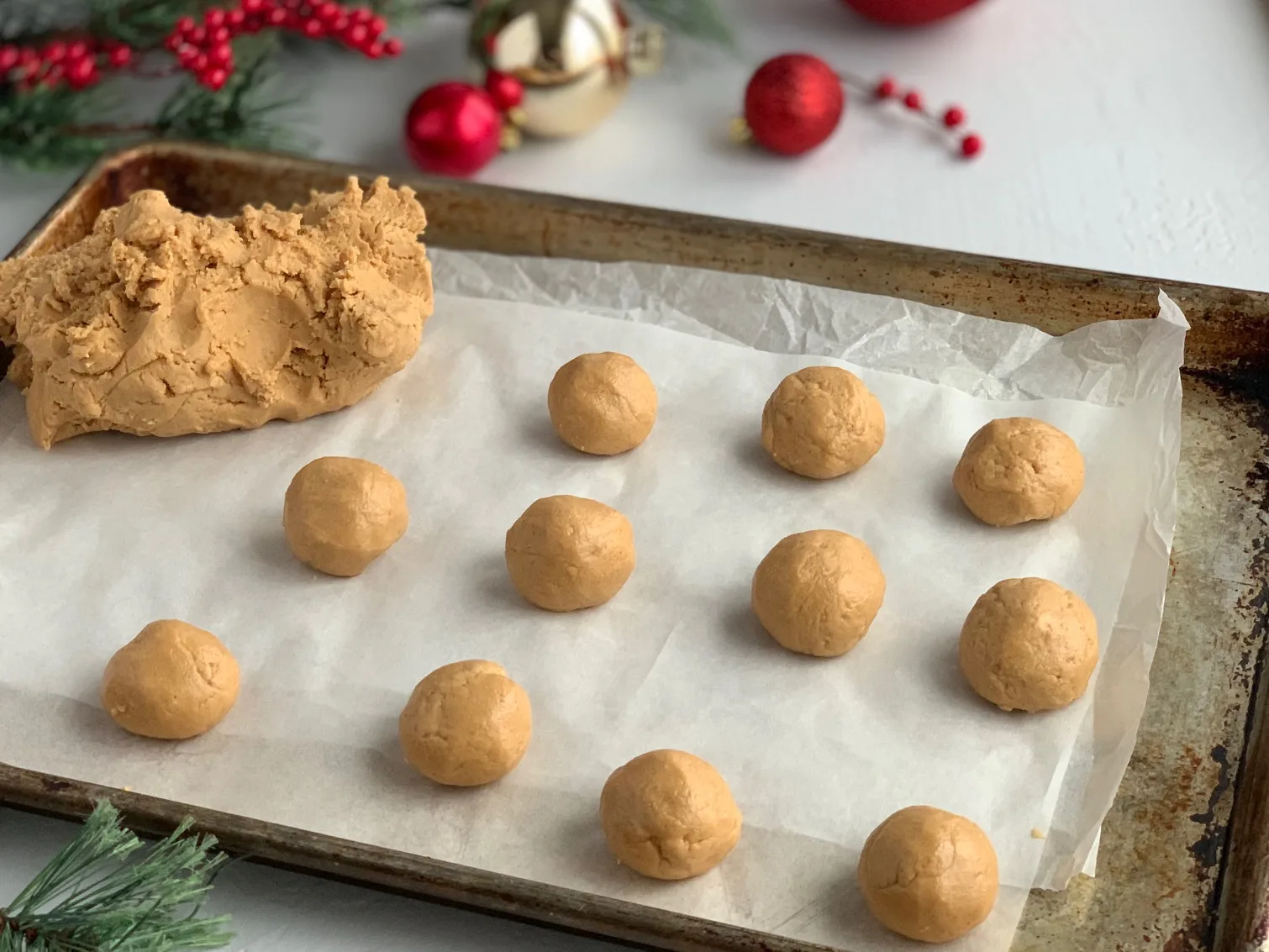 Buckeye balls on a baking sheet before they're dipped in chocoalte