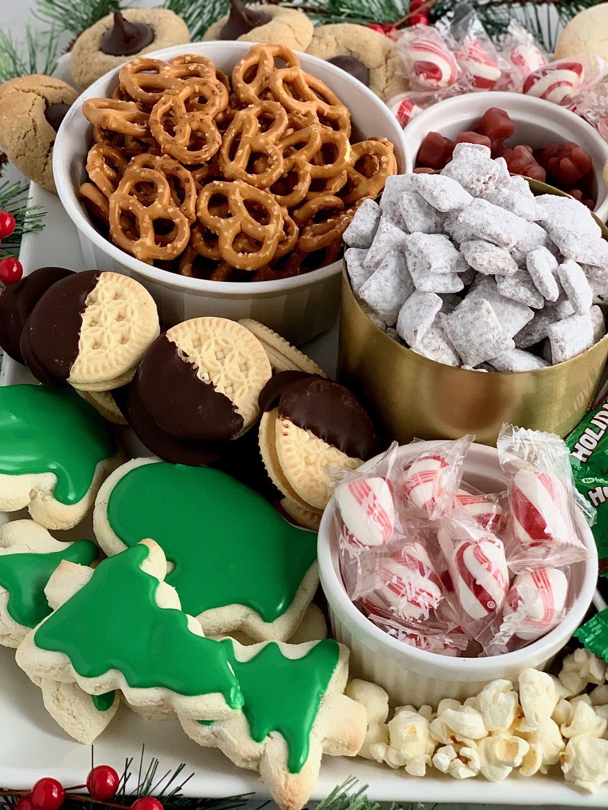 a close up of gluten and dairy free treats on a Christmas dessert board.