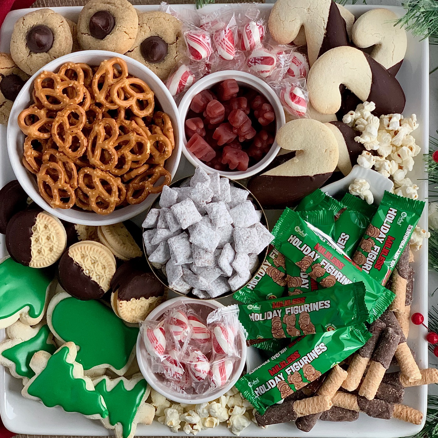 a variety of gluten and dairy free treats on a Christmas dessert board