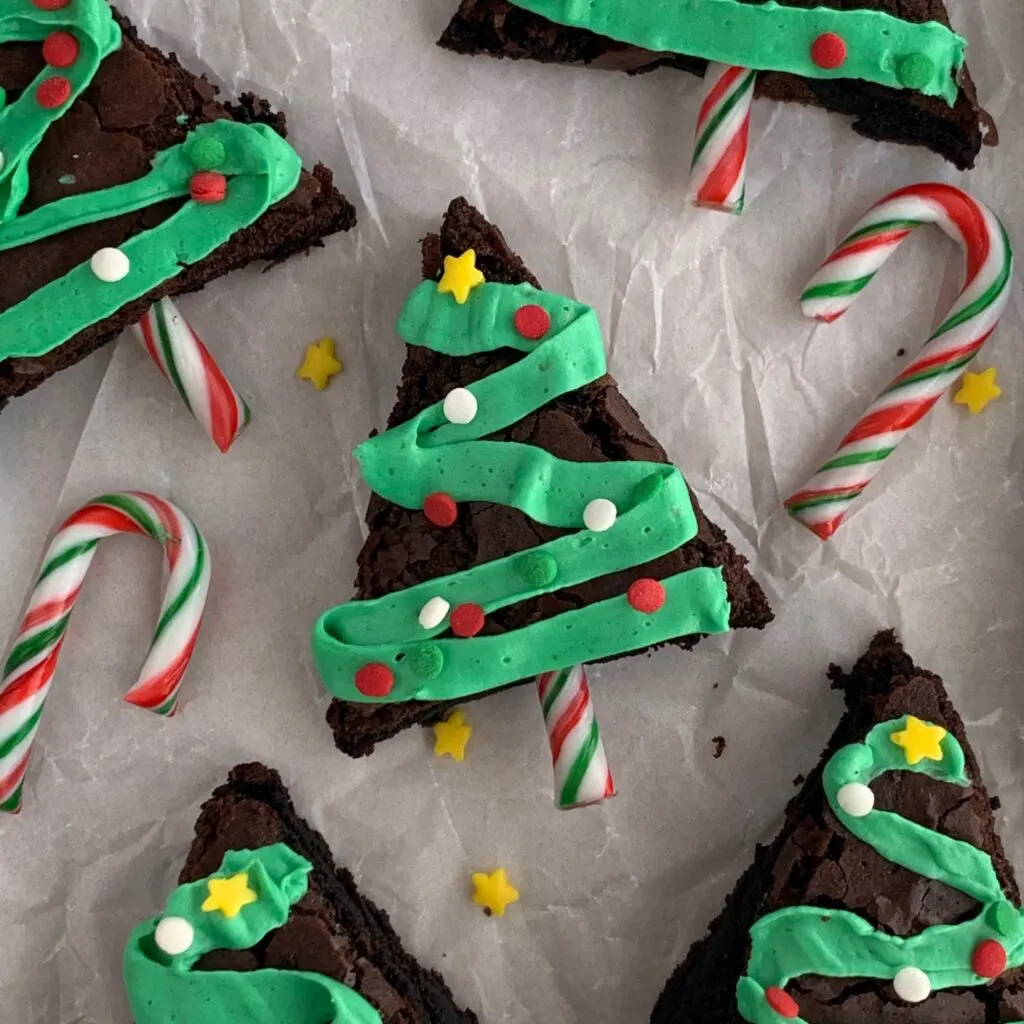 Christmas tree brownies decorated with frosting tinsel and sprinkles