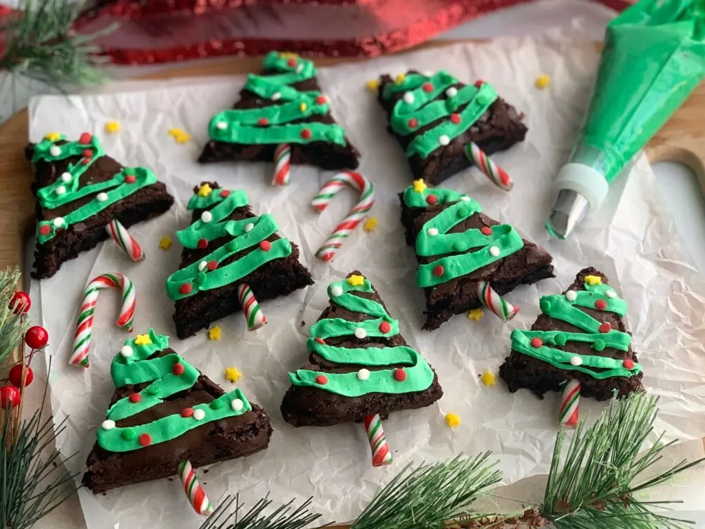 Christmas trees made from brownies with frosting tinsel and sprinkles