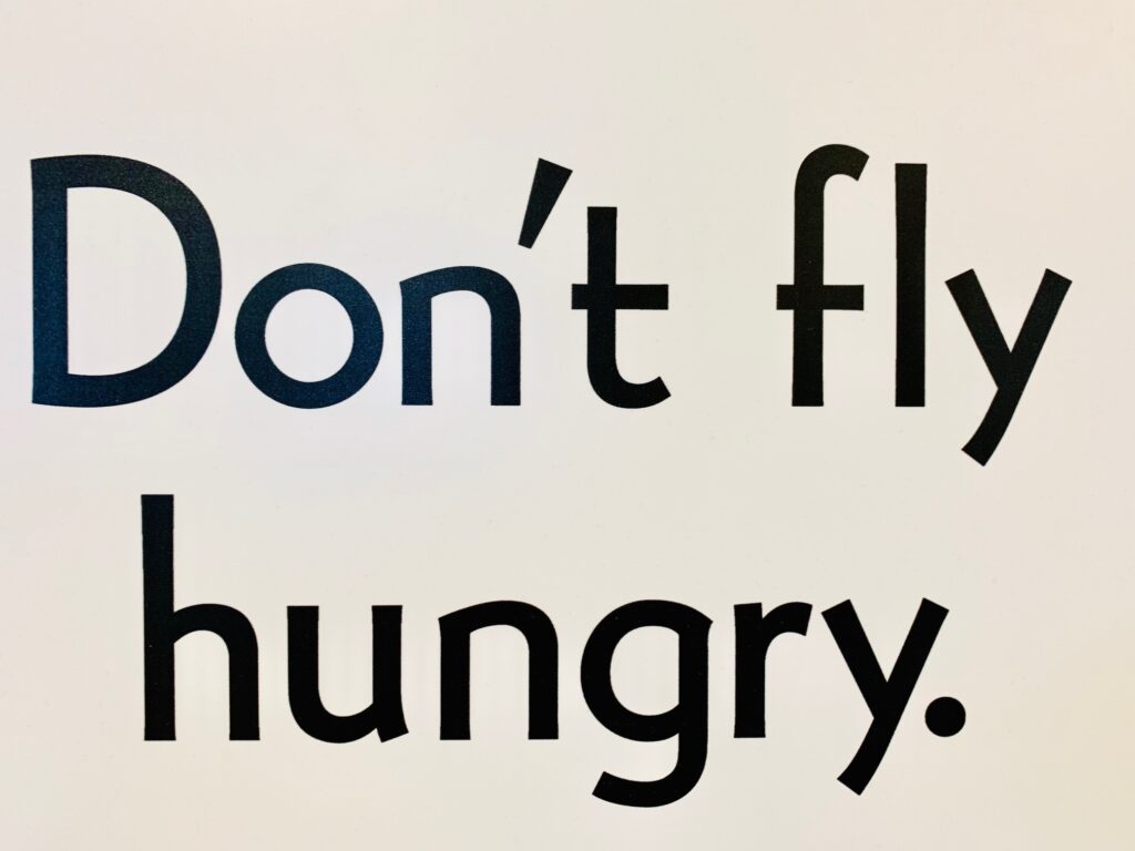 A picture that says, "Don't fly hungry."