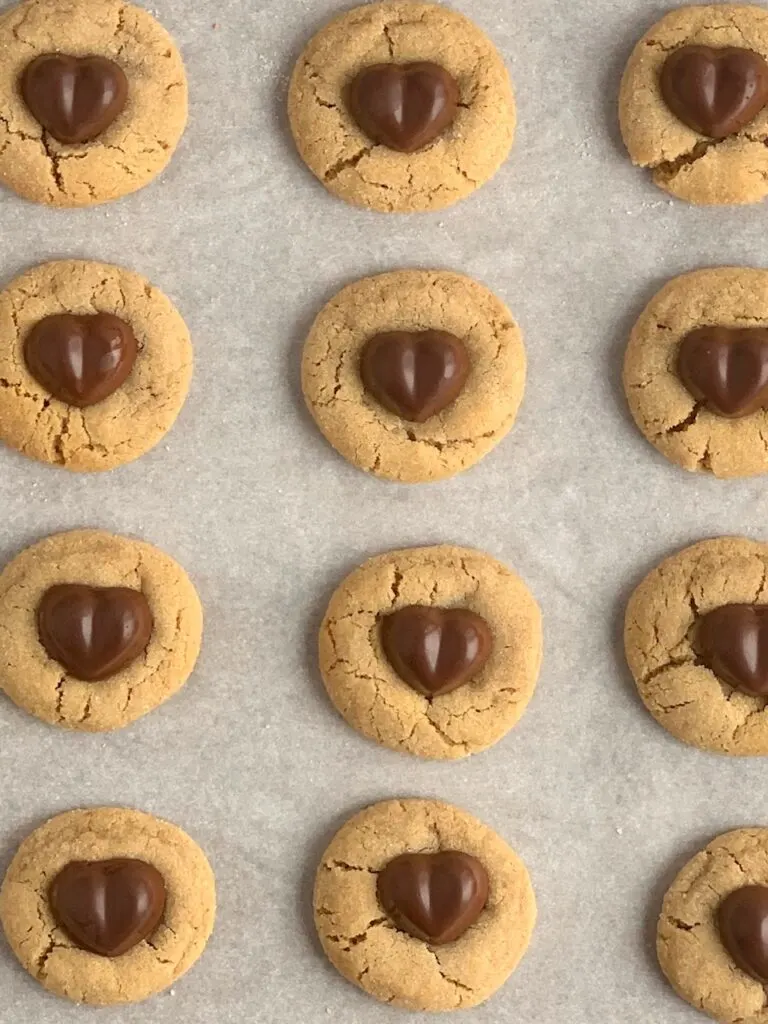 Heart Peanut Butter Blossom cookies on a baking sheet