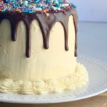 cake with chocolate ganache drizzle and sprinkles on top