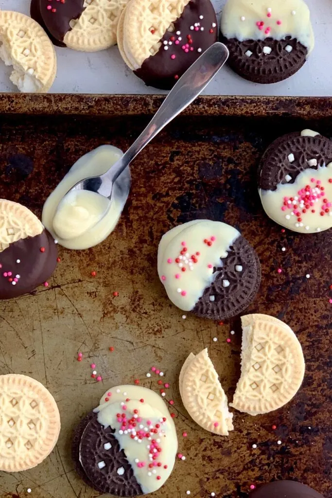 gluten and dairy free oreo sandwich cookies dipped in melted chocolate with Valentine sprinkles