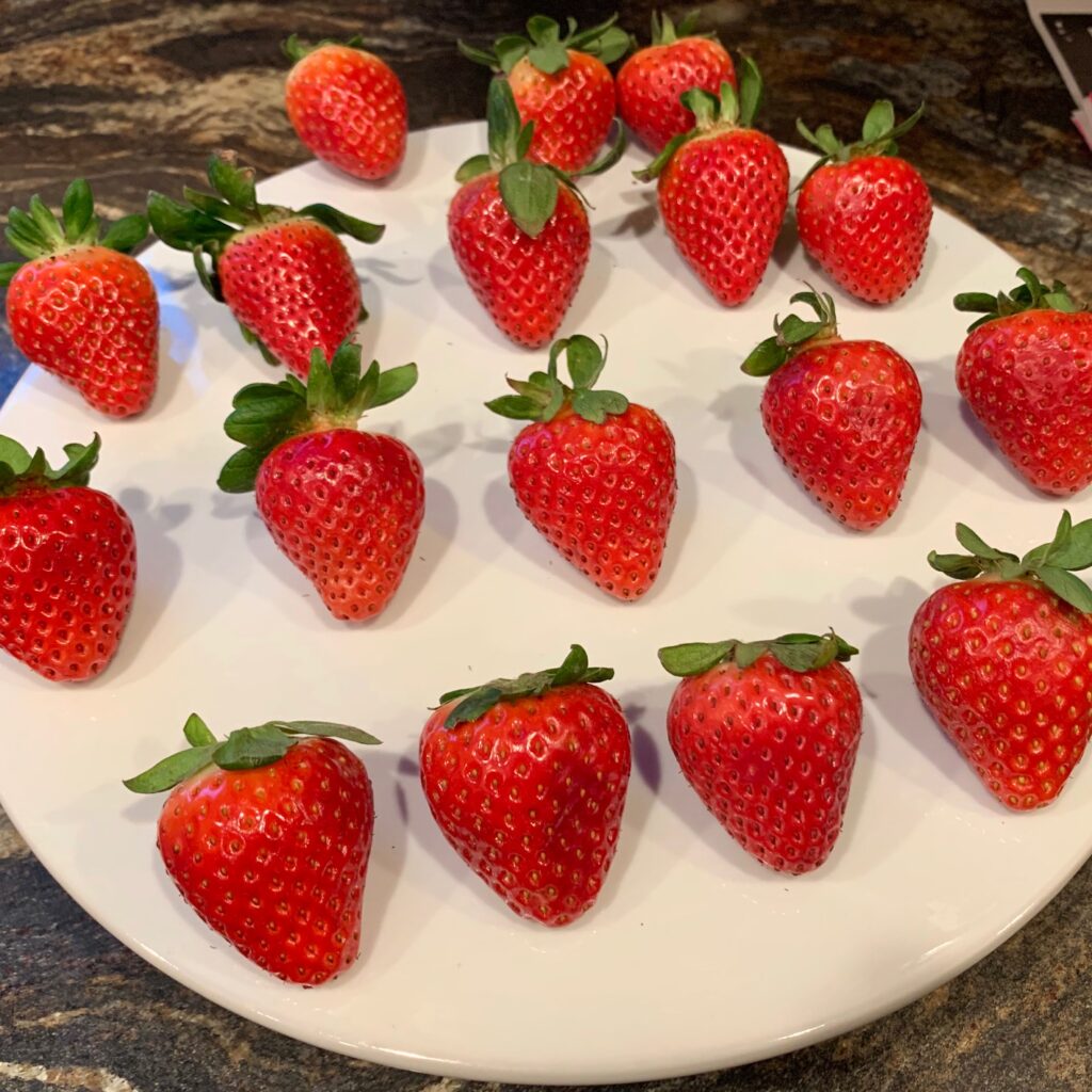 strawberries lined up on a platter