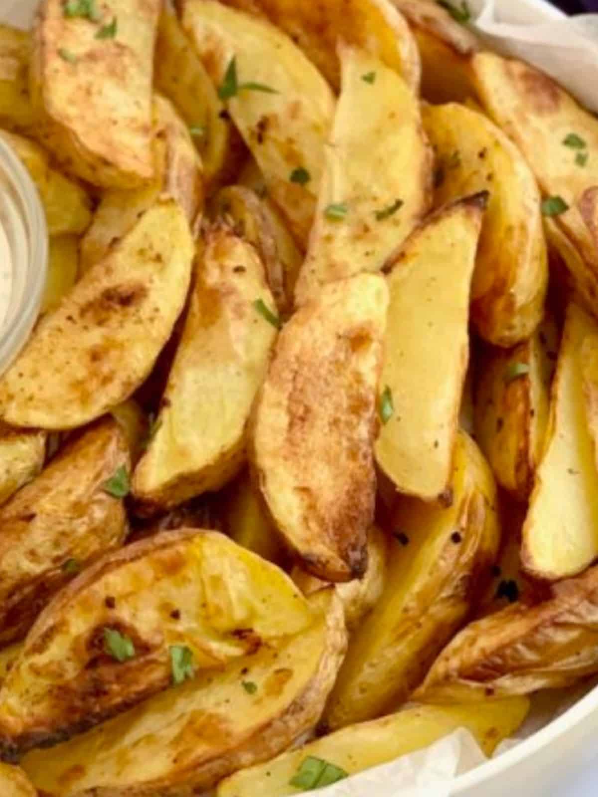 Looking down on a ton of gluten free potato wedges.