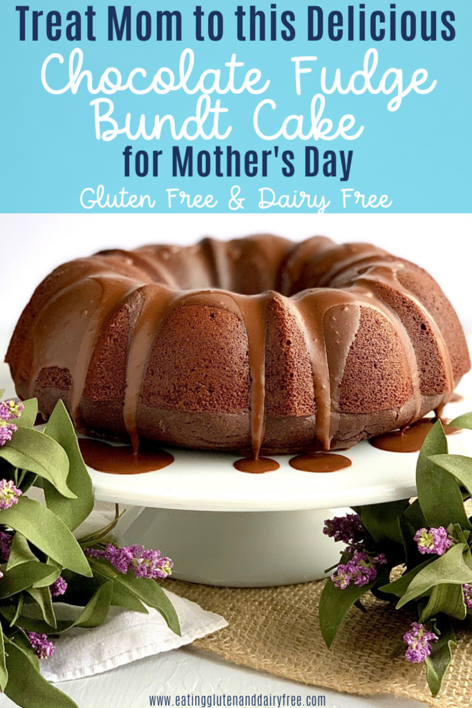 A decadent chocolate bundt cake on a cake plate surround by spring flowers.