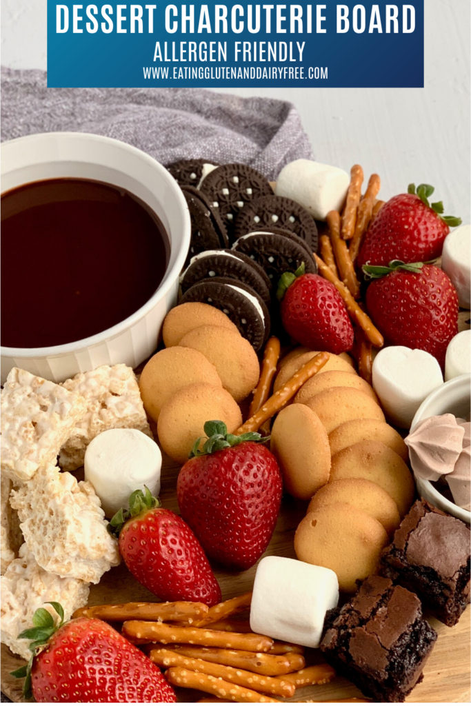 A variety of treats such as oreo cookies, strawberries, marshmallows, pretzel rods, marshmallow treats and ganache dipping sauce.