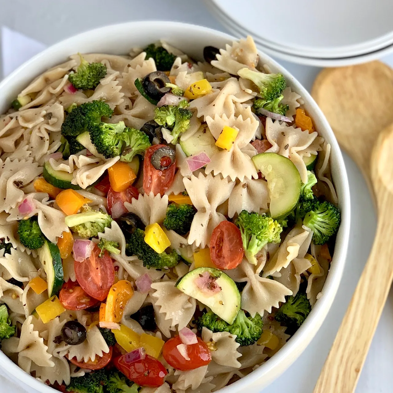 A serving bowl filled with delicious veggie pasta salad.