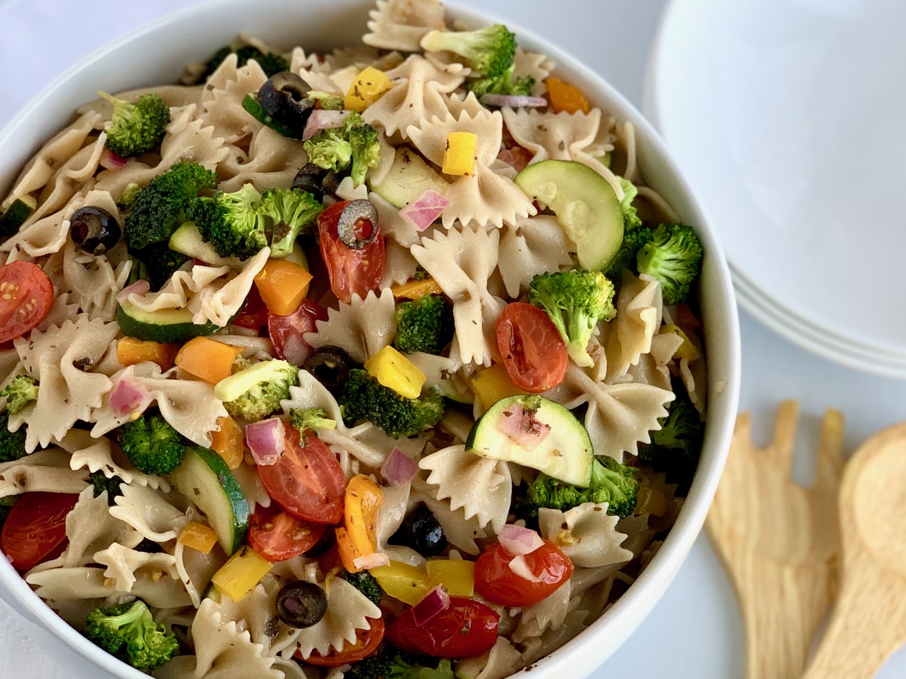 A serving bowl filled with delicious veggie pasta salad.