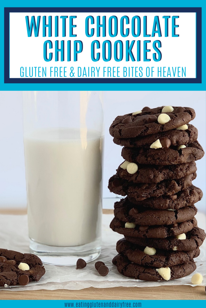 A stack of white chocolate chip cookies next to a glass of almond milk.
