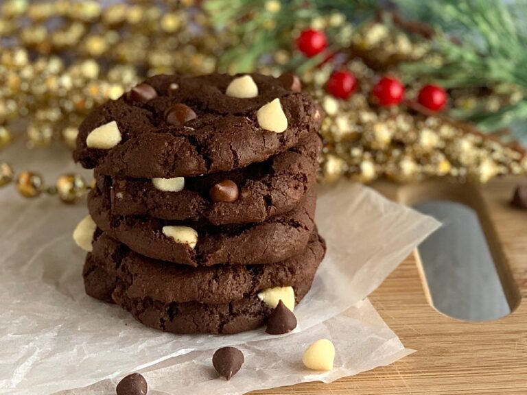 A stack of 3 chocolate cookies with white chocolate chips
