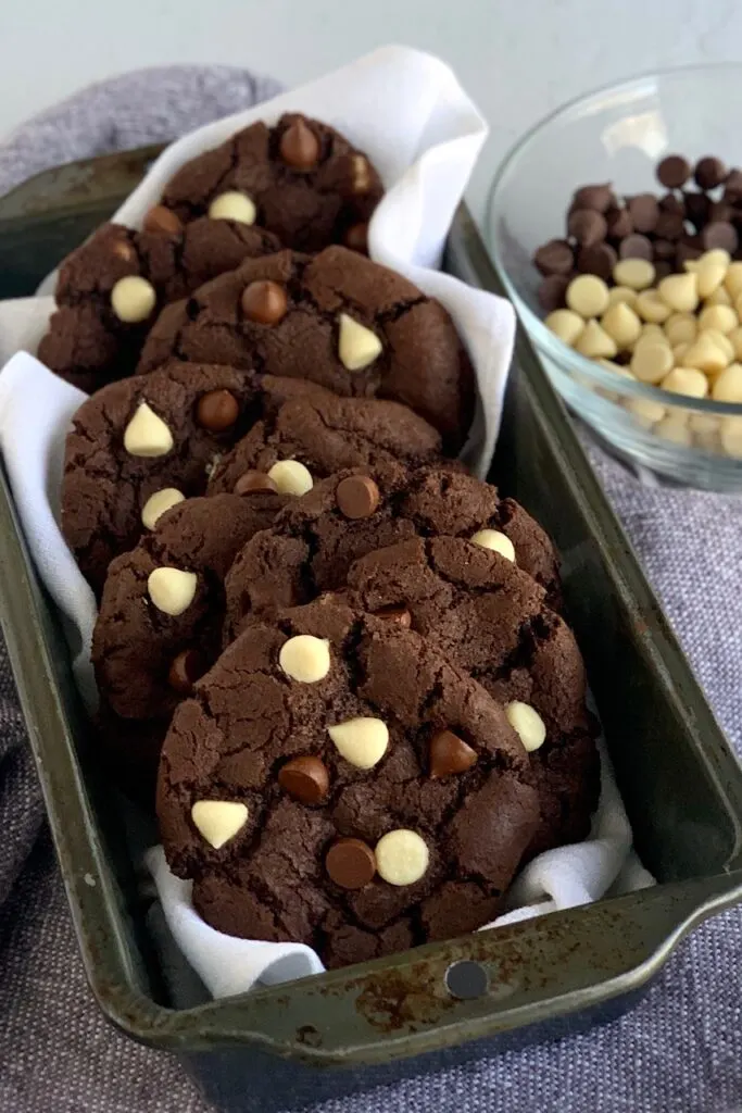 White chocolate chip cookies lined up in a loaf pan.