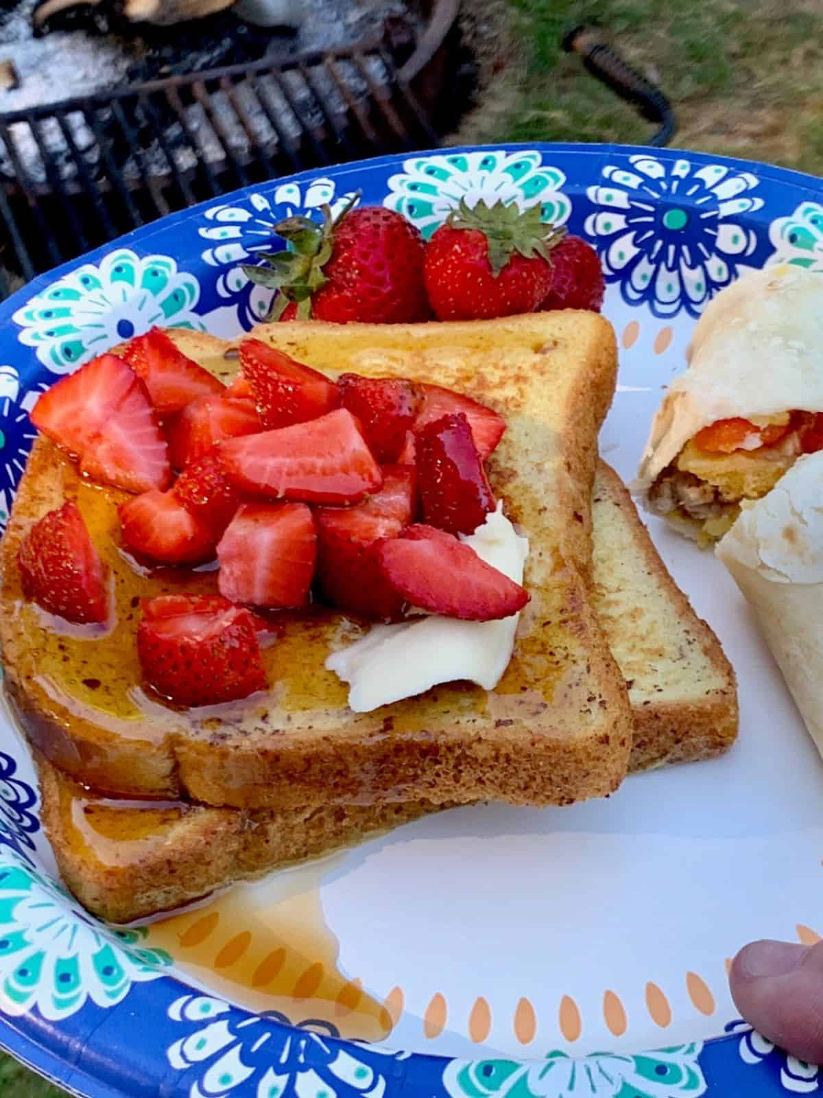French toast and fruit on a plate.