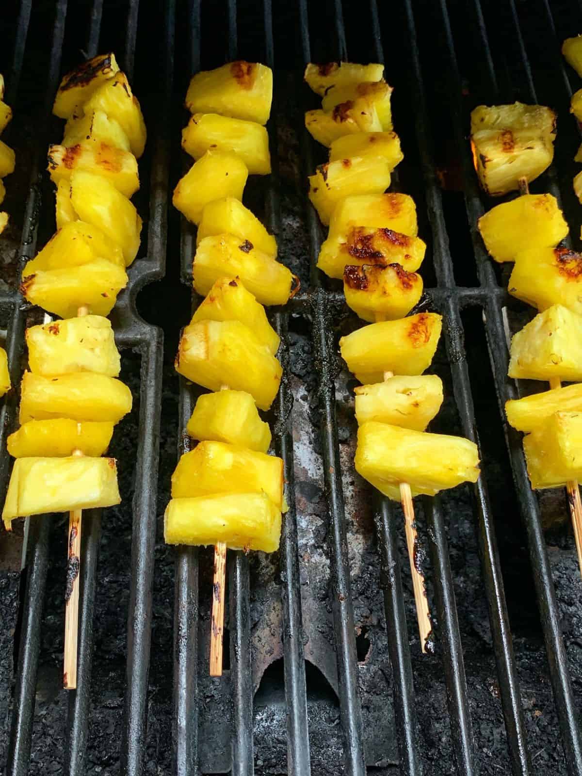 Pineapple skewers on a grill.