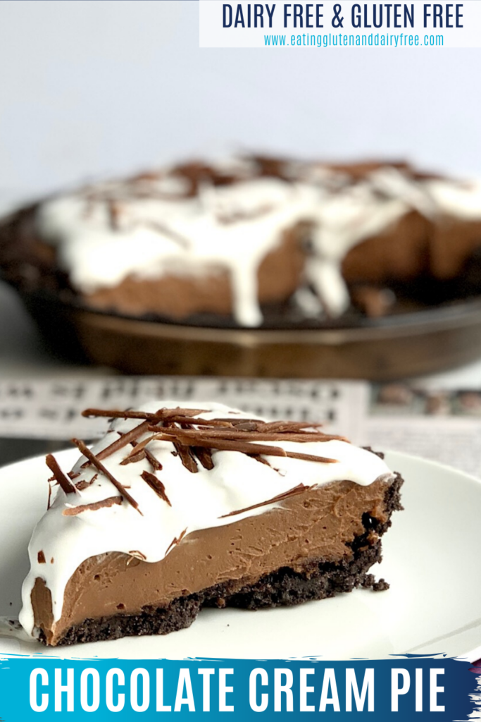 A slice of pie with an oreo crust, chocolate cream filling, whipped topping, and chocolate shavings.