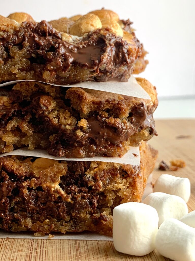 3 stacked s'more cookie bars with melted chocolate