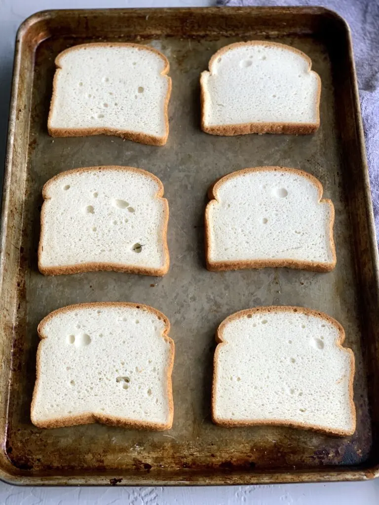 A baking sheet with 6 slices of bread on it