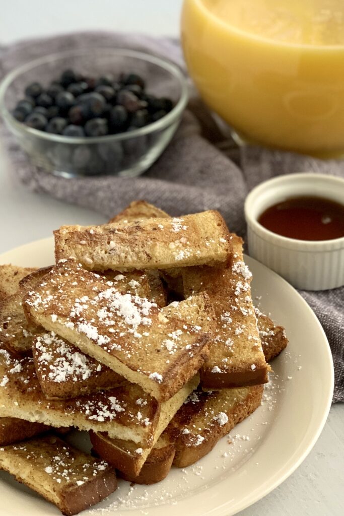 A plate heaping with french toast sticks