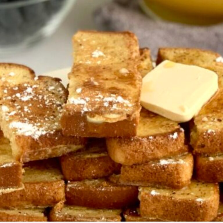 A small stack of gluten free french toast sticks with dairy free butter.