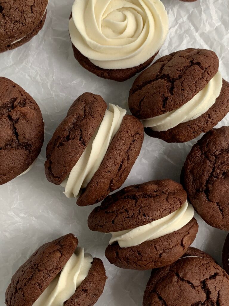 Buttercream frosting sandwiched between 2 fudgy brownie cookies.