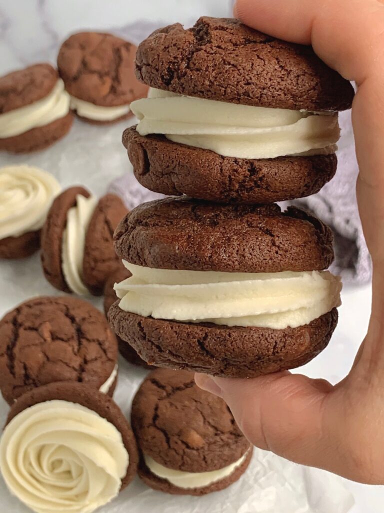 Buttercream frosting sandwiched between fudgy brownie cookies.