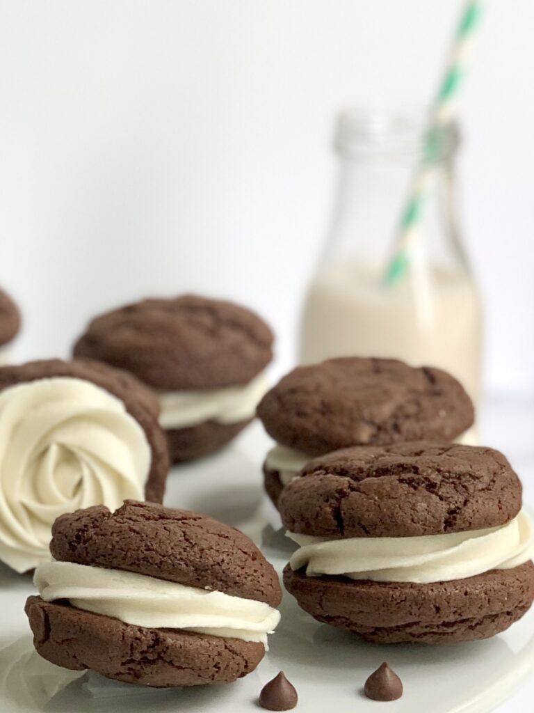 Buttercream frosting sandwiched between fudgy brownie cookies.