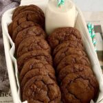 Fudgy brownie cookies in a pan with a glass of dairy free milk