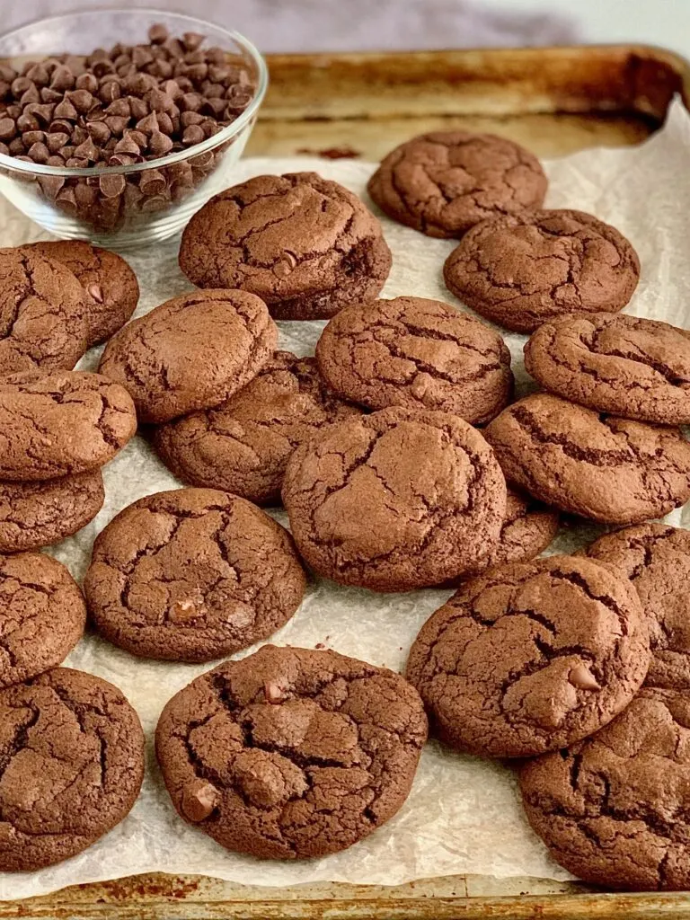 A pile of Fudgy brownie cookies on a cookie sheet.