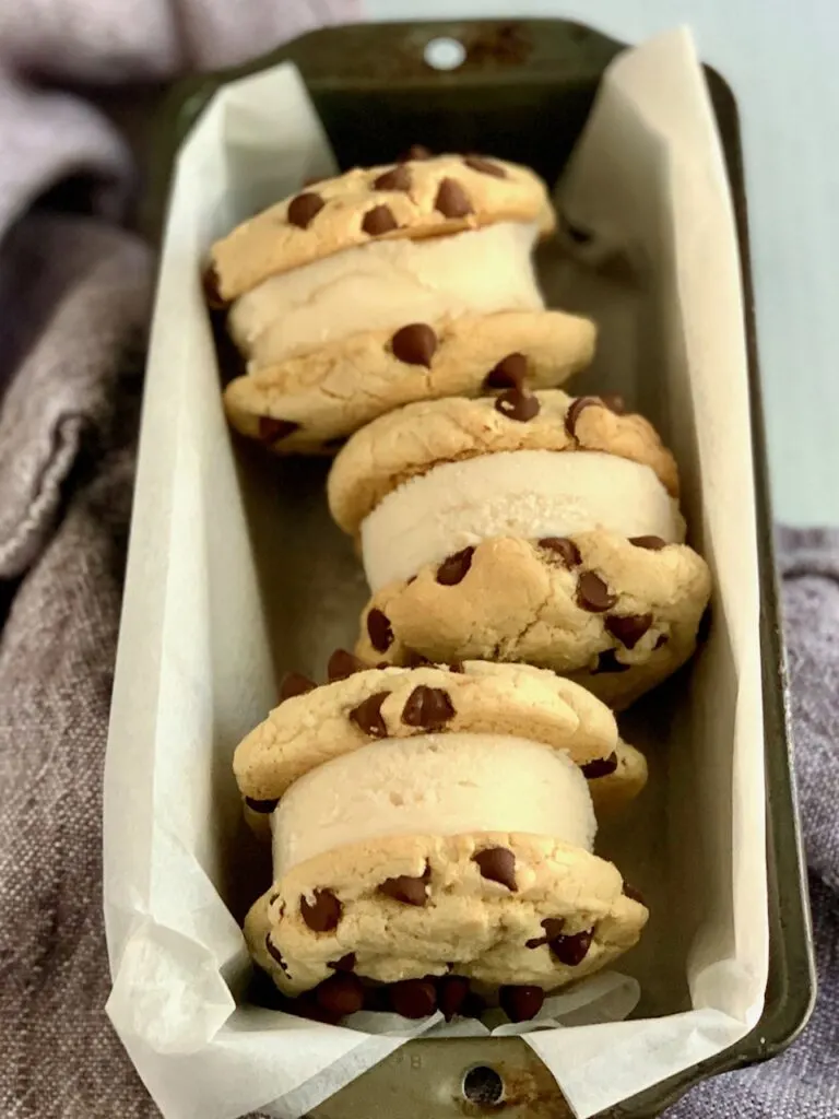 three ice cream sandwiches in a bread tin.