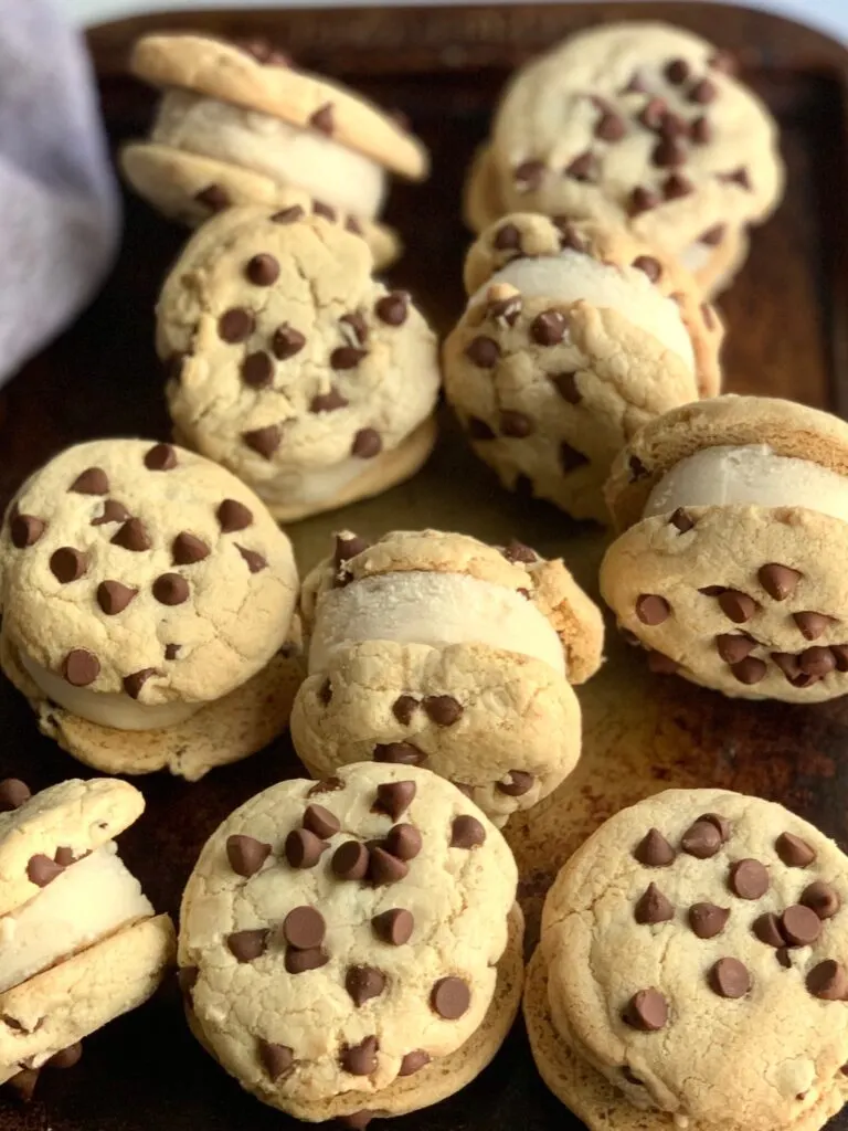 Ice cream sandwiched between two chocolate chip cookies.