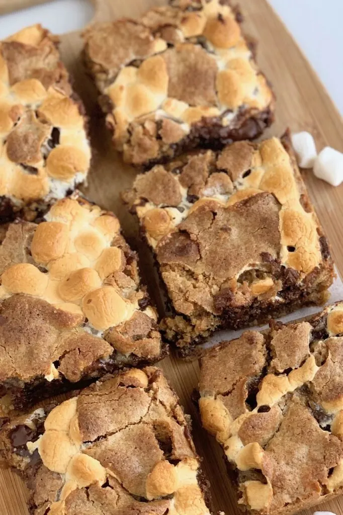 Yummy S'more cookie  bars with layers of melted chocolate, marshmallow and cookie dough.