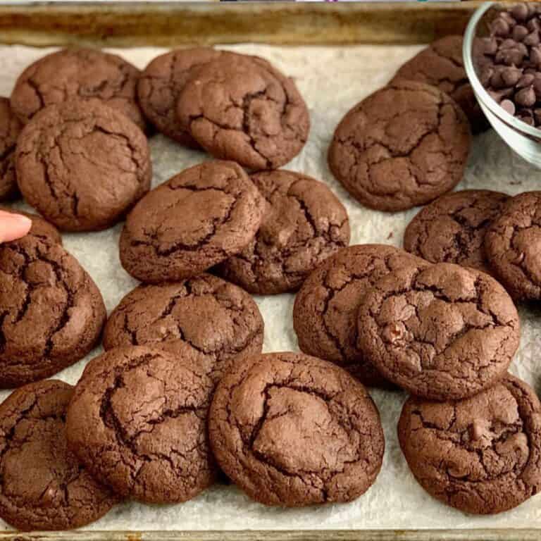 Fudgy Brownie Cookies on a lined sheet pan.