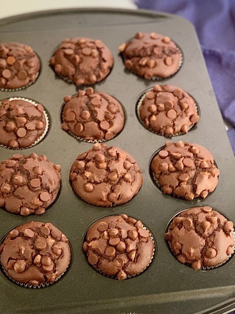 Double chocolate muffins in a muffin pan.