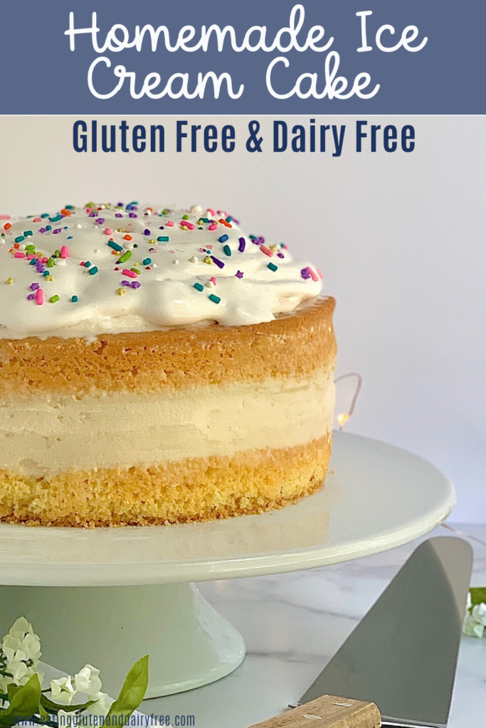 Ice cream sandwiched between a top and bottom layer of cake. With whipped topping and spinkles on top.