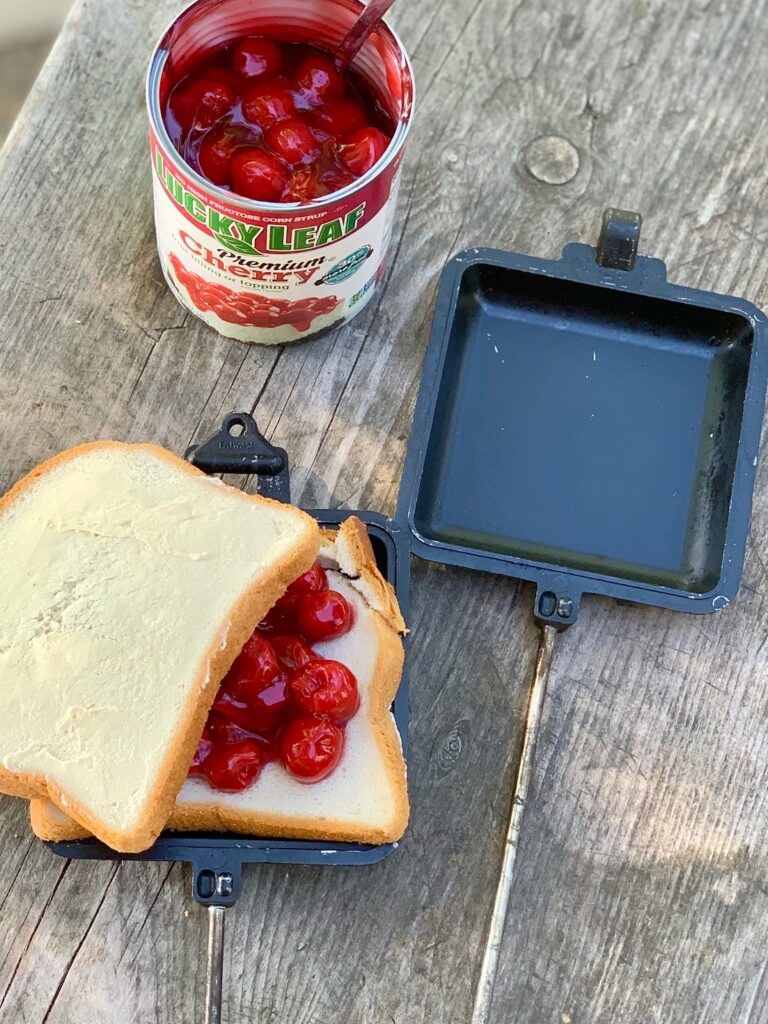 A slice of bread with cherry pie filling