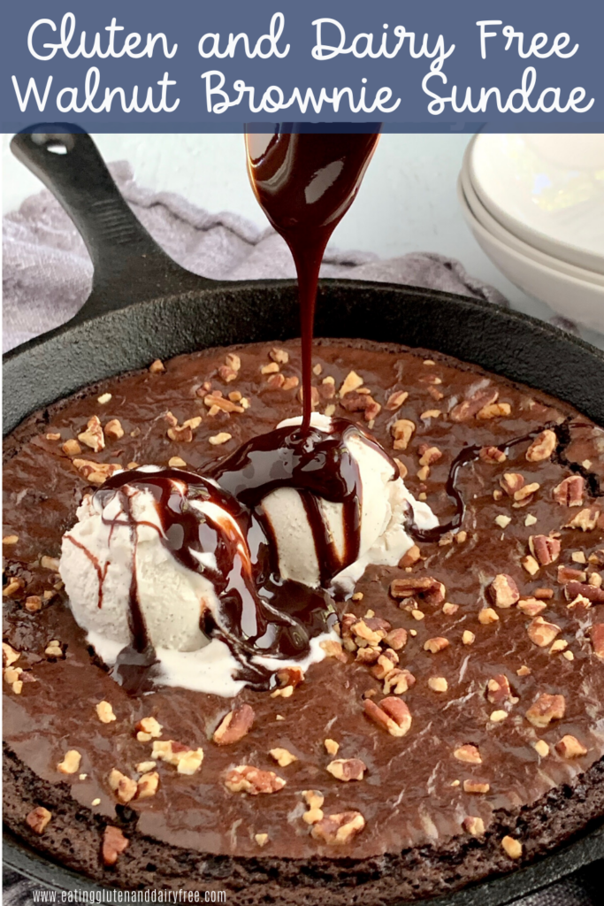 A walnut brownie skillet with a dollop of ice cream and chocolate sauce.